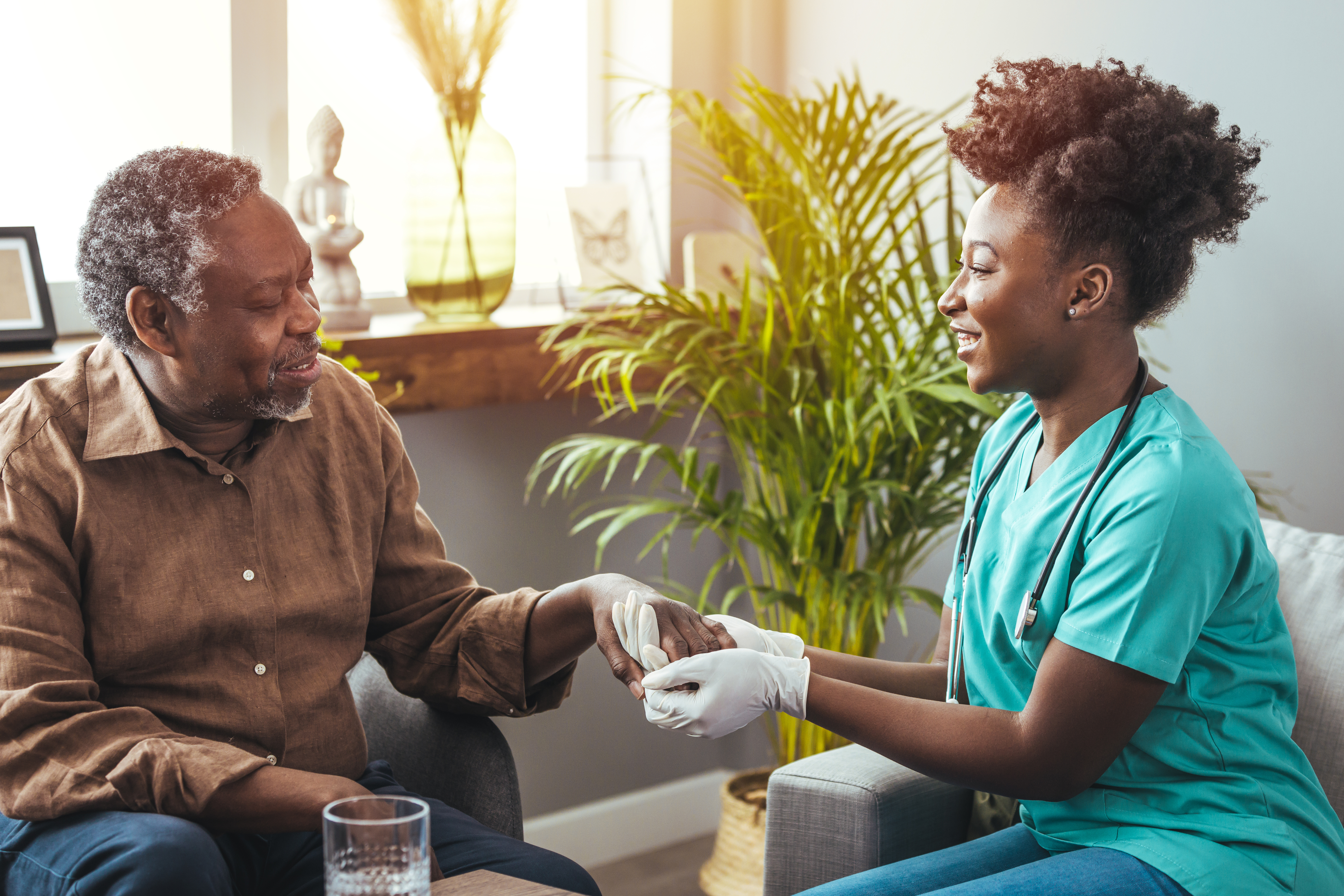 An image of a healthcare professional sitting with a patient who has progressed through the 7 stages of Lewy body dementia.