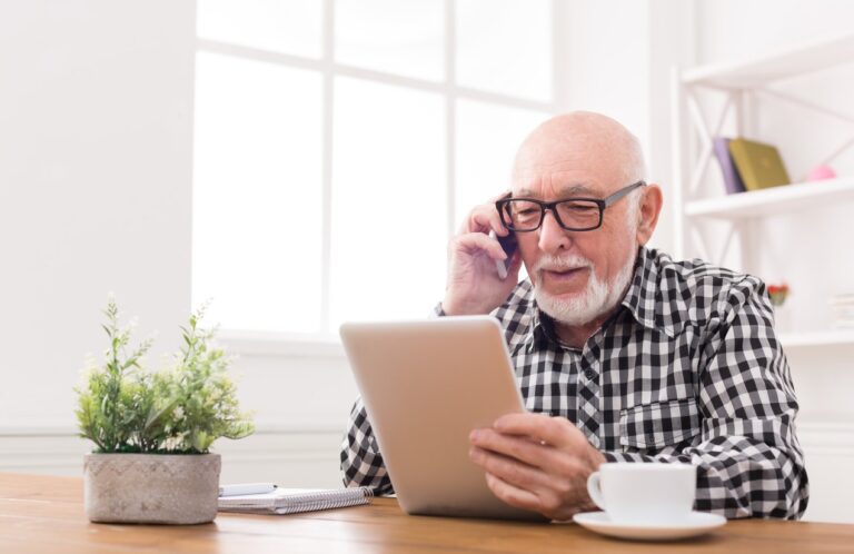 elderly man using tablet