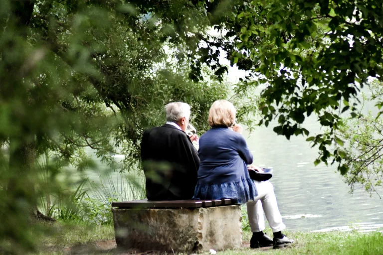 senior couple enjoying lake view together