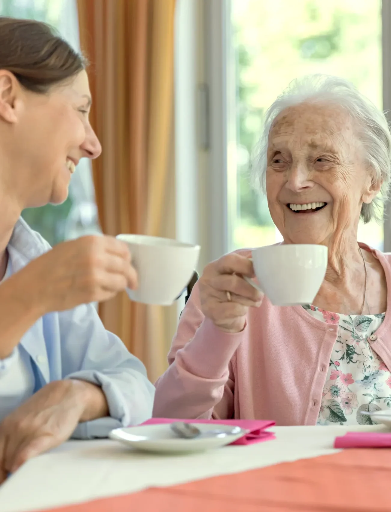 senior woman drinking coffee with someone